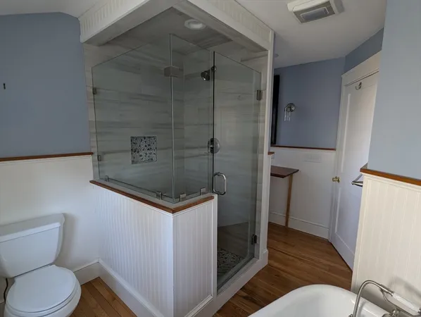 a bathroom with a toilet and a shower
