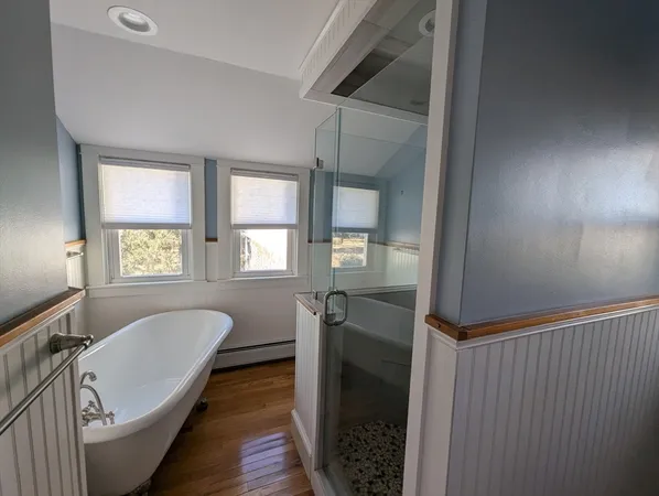 a en suite bathroom with a tub sink and mirror
