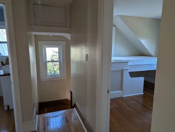 a view of hallway with wooden floor