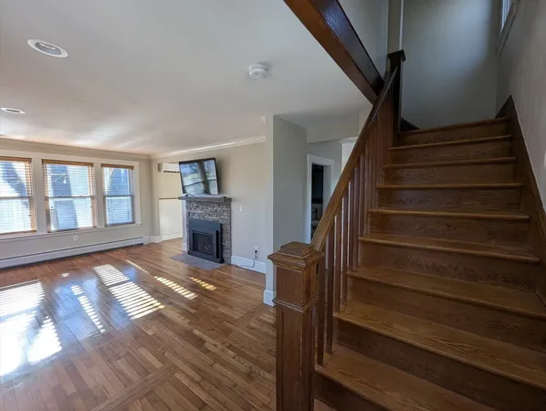 a view of entryway and hall with wooden floor