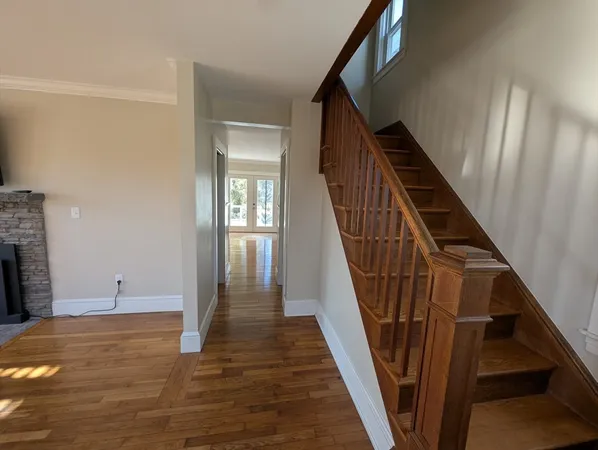 a view of an entryway with wooden floor and stair