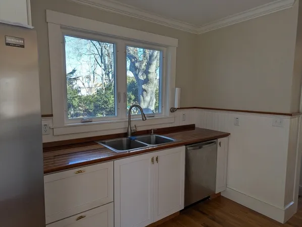 a kitchen with a sink and large window