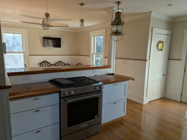 a kitchen with stainless steel appliances granite countertop a stove and a refrigerator