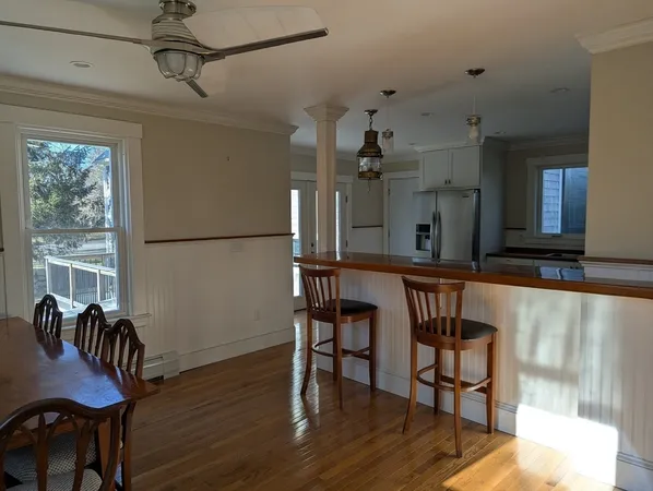 a view of a room with furniture and wooden floor