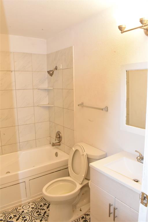 6040 Prothrow Street Fort Worth, TX 76112 - Photo 4 of 8 a bathroom with a sink a toilet and a bathtub