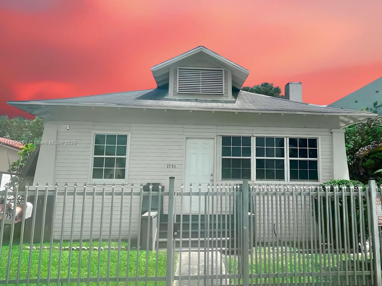 1759 Northwest 18th Terrace Miami, FL 33125 - Photo 1 of 5 a front view of a house with a garden