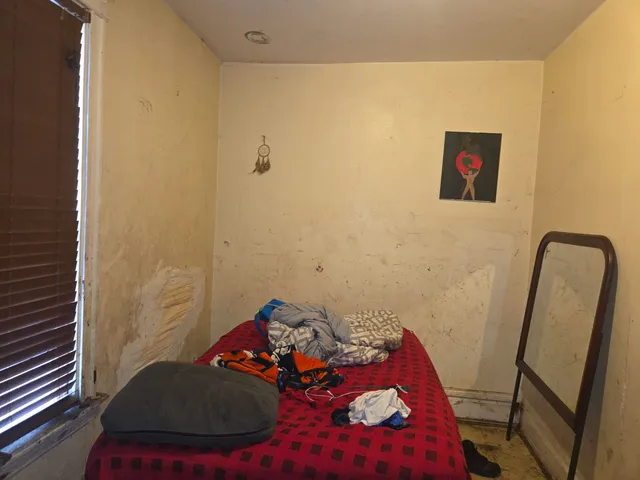 a bedroom with a bed and a couch