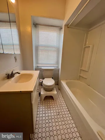 a bathroom with a sink a toilet and bathtub
