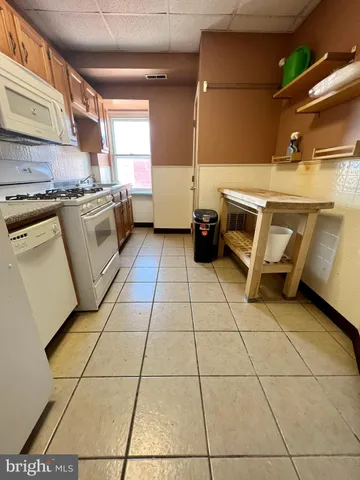 a kitchen with a sink a stove and cabinets