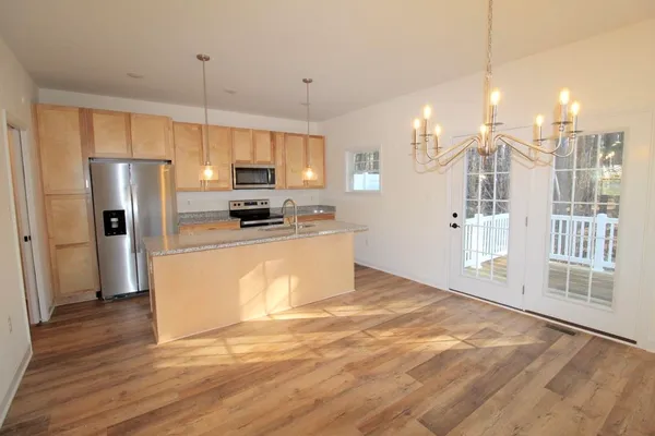a kitchen with stainless steel appliances a refrigerator sink and microwave