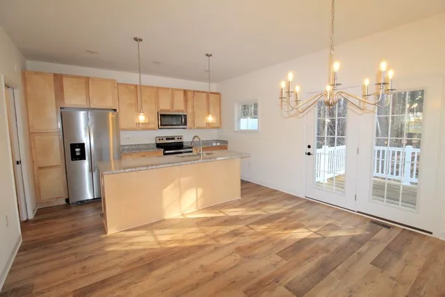 a kitchen with stainless steel appliances a refrigerator sink and microwave
