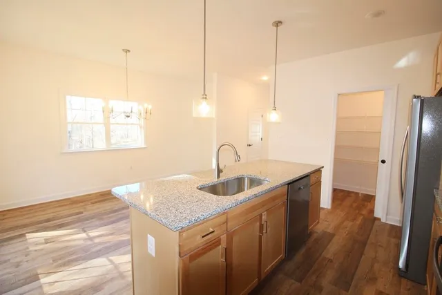 a kitchen with sink cabinets and wooden floor