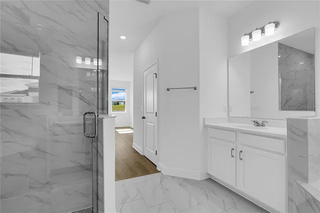 a bathroom with a tub a sink and mirror