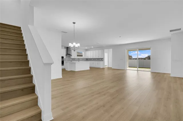 a view of a room with wooden floor and staircase