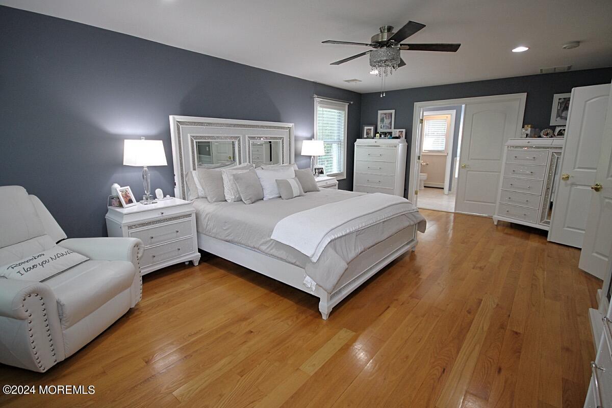111 Wiseman Road Jackson, NJ 08527 - Photo 16 of 65 a bedroom with a large bed and a chandelier
