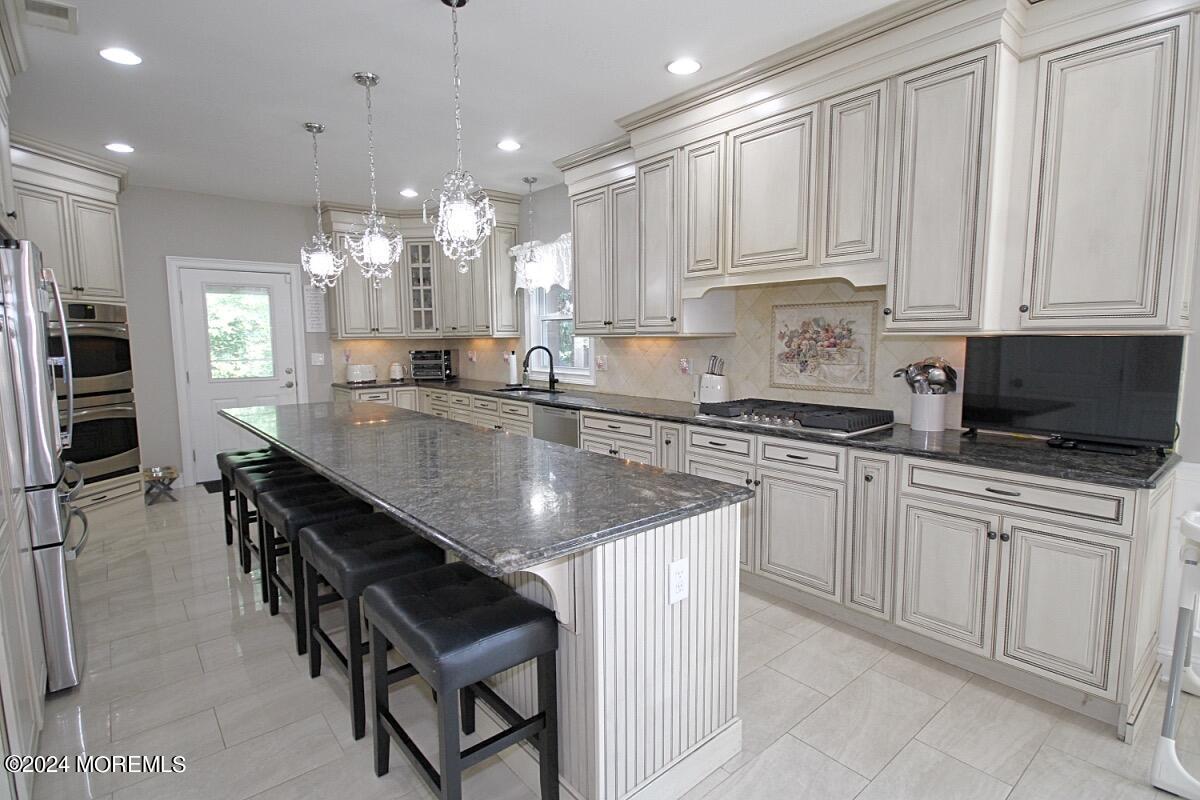 111 Wiseman Road Jackson, NJ 08527 - Photo 2 of 65 a kitchen with kitchen island granite countertop counter space a sink stainless steel appliances and cabinets