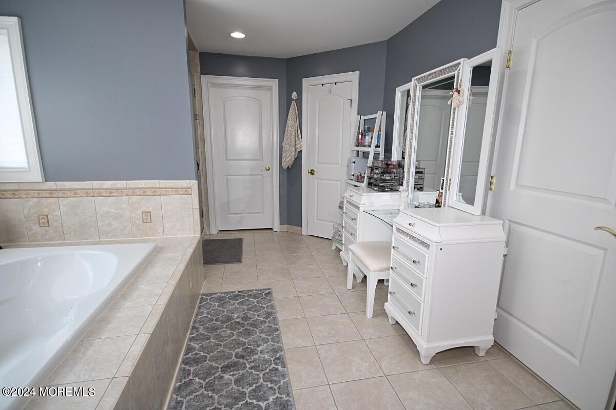111 Wiseman Road Jackson, NJ 08527 - Photo 21 of 65 a bathroom with a tub sink and mirror