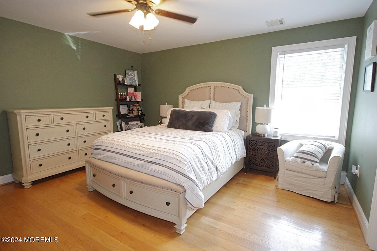 111 Wiseman Road Jackson, NJ 08527 - Photo 24 of 65 a bedroom with a bed and a chandelier