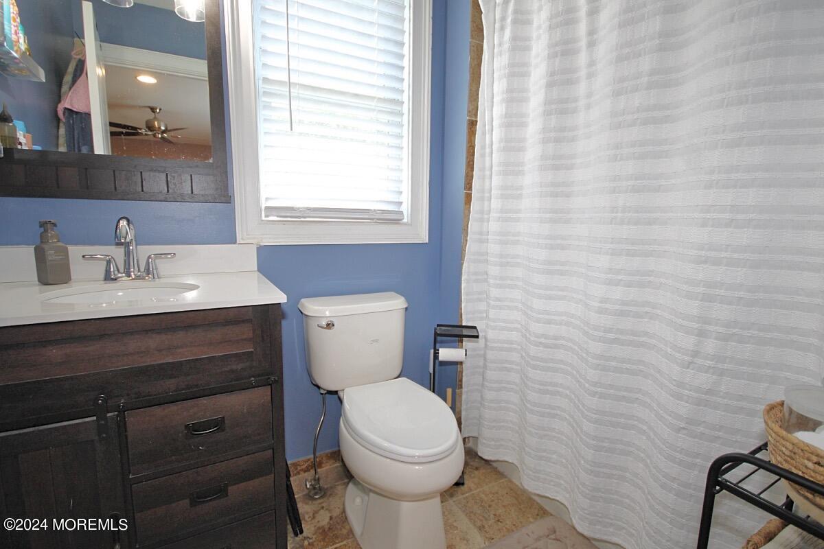 111 Wiseman Road Jackson, NJ 08527 - Photo 45 of 65 a bathroom with a toilet a sink a mirror and a window