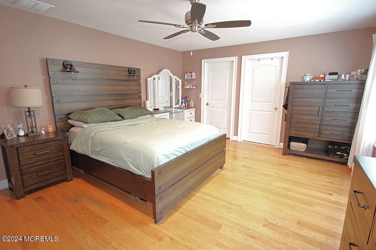 111 Wiseman Road Jackson, NJ 08527 - Photo 46 of 65 a large bed sitting in a room next to a window