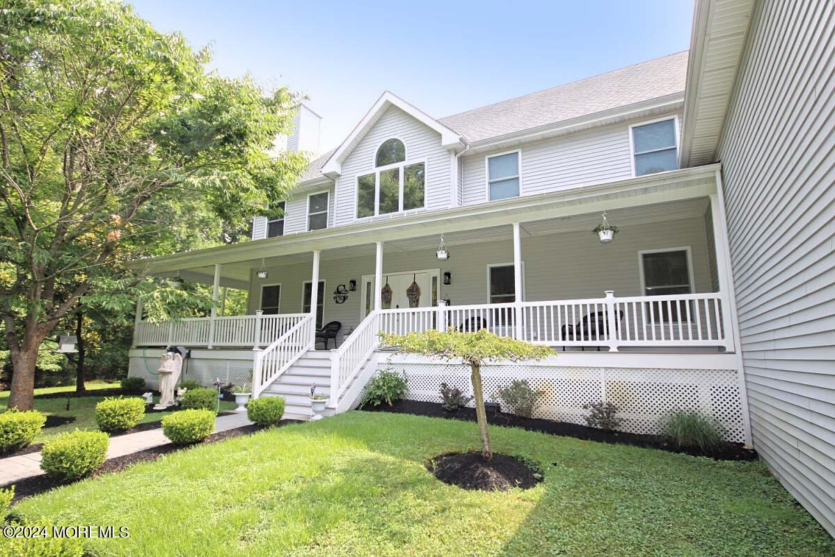 111 Wiseman Road Jackson, NJ 08527 - Photo 64 of 65 a front view of a house with a garden and porch