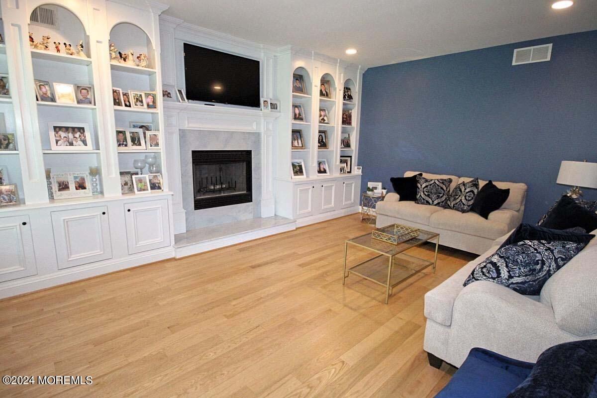 111 Wiseman Road Jackson, NJ 08527 - Photo 8 of 65 a living room with furniture and a fireplace