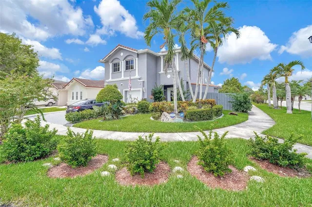 a front view of a house with a yard and outdoor seating