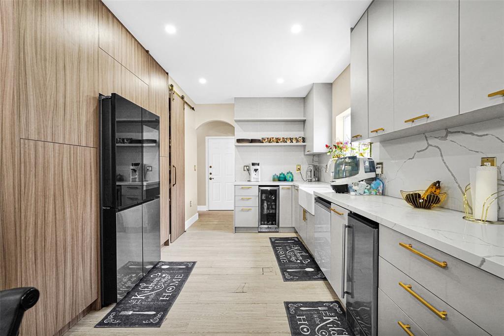 14402 Southwest 157th Path Miami, FL 33196 - Photo 11 of 80 a kitchen with a sink a refrigerator and cabinets