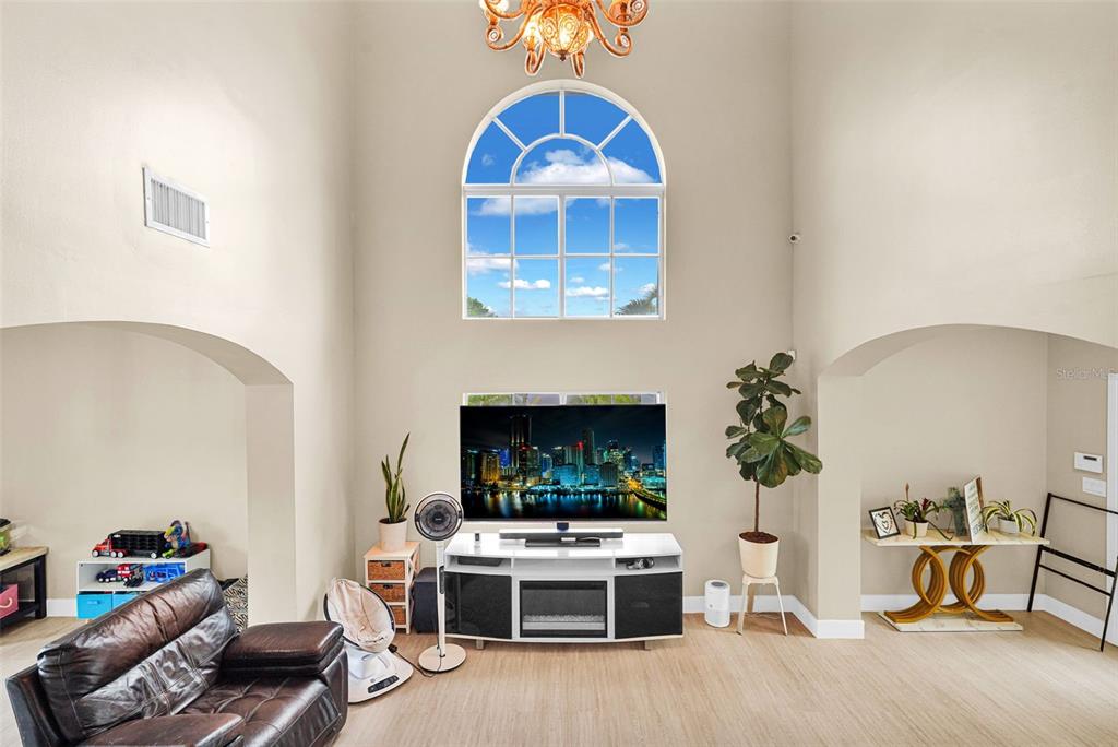 14402 Southwest 157th Path Miami, FL 33196 - Photo 16 of 80 a living room with furniture a fireplace and a table