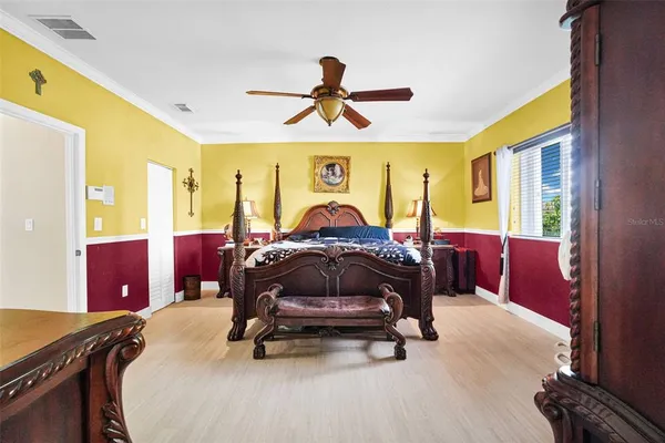 a view of a hallway with wooden floor and a living room