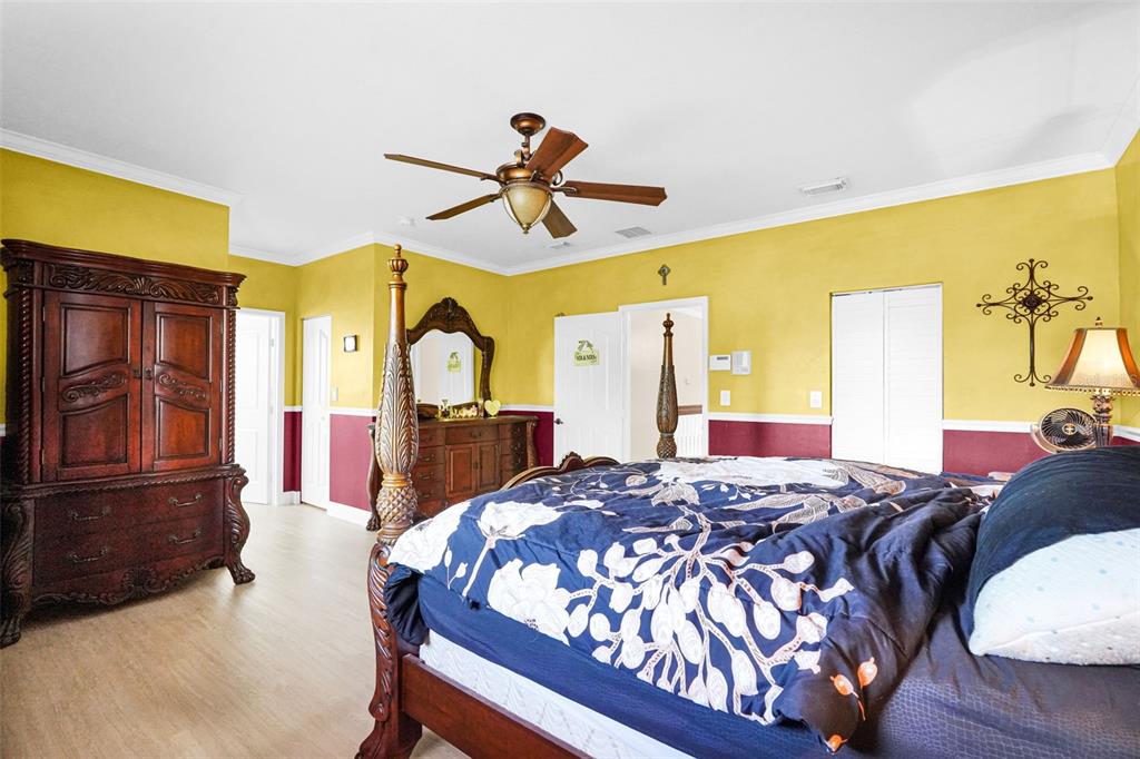 14402 Southwest 157th Path Miami, FL 33196 - Photo 31 of 80 a bed sitting in a bedroom next to a window