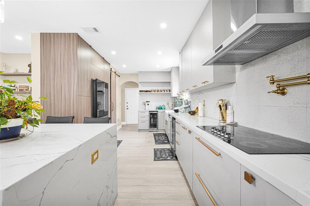 14402 Southwest 157th Path Miami, FL 33196 - Photo 6 of 80 a large kitchen with stainless steel appliances lots of counter space and wooden floor