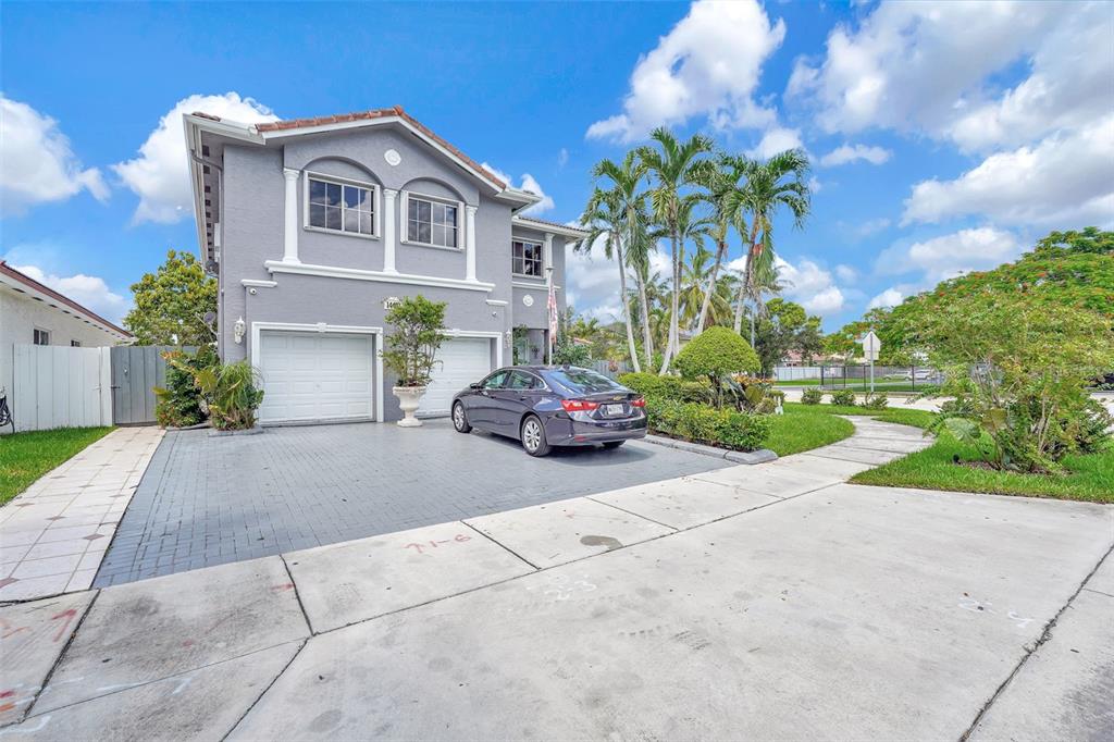 14402 Southwest 157th Path Miami, FL 33196 - Photo 63 of 80 a car parked in front of a house with a yard