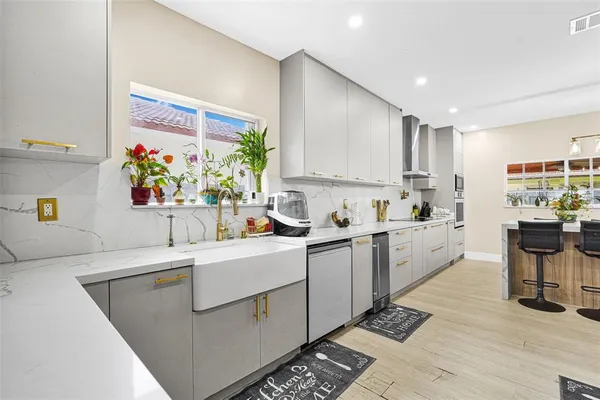 a kitchen with a sink cabinets and window
