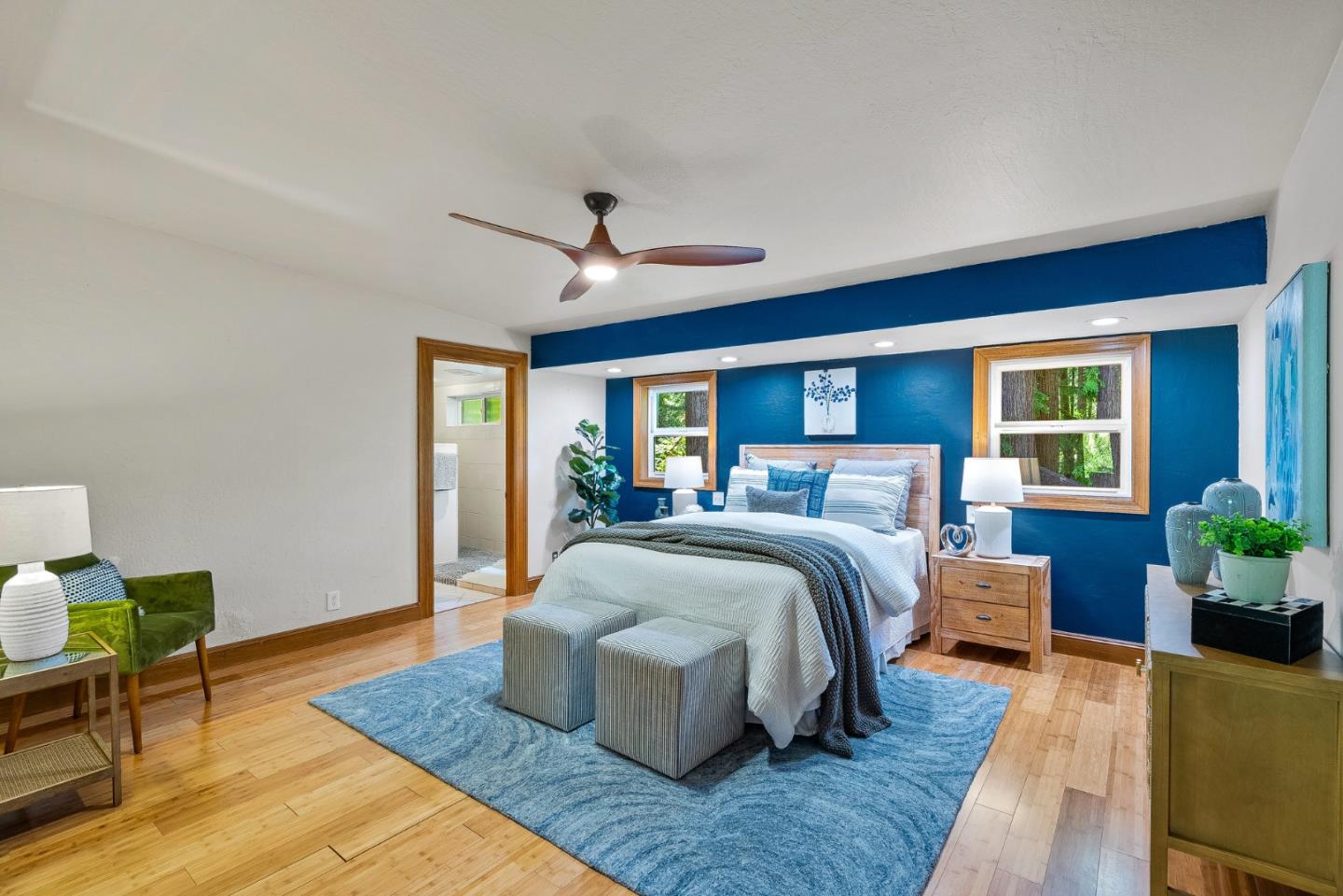 11150 Riverside Road Brookdale, CA 95005 - Photo 27 of 55 a spacious bedroom with a bed a couch and potted plant with the outer view