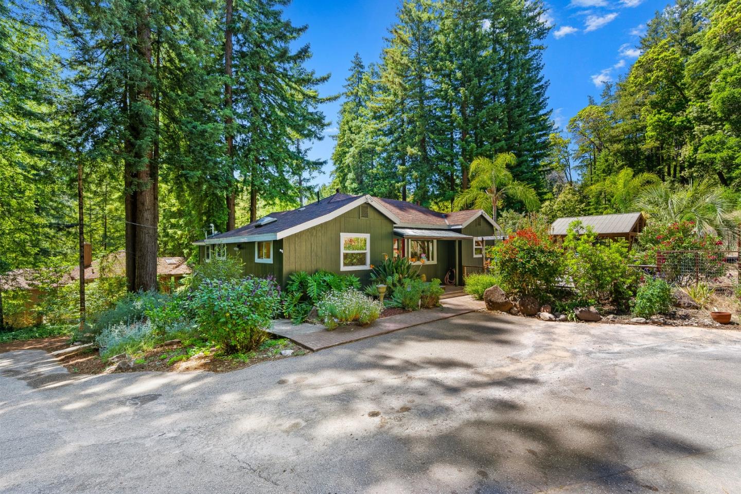 11150 Riverside Road Brookdale, CA 95005 - Photo 4 of 55 a front view of a house with a yard and trees