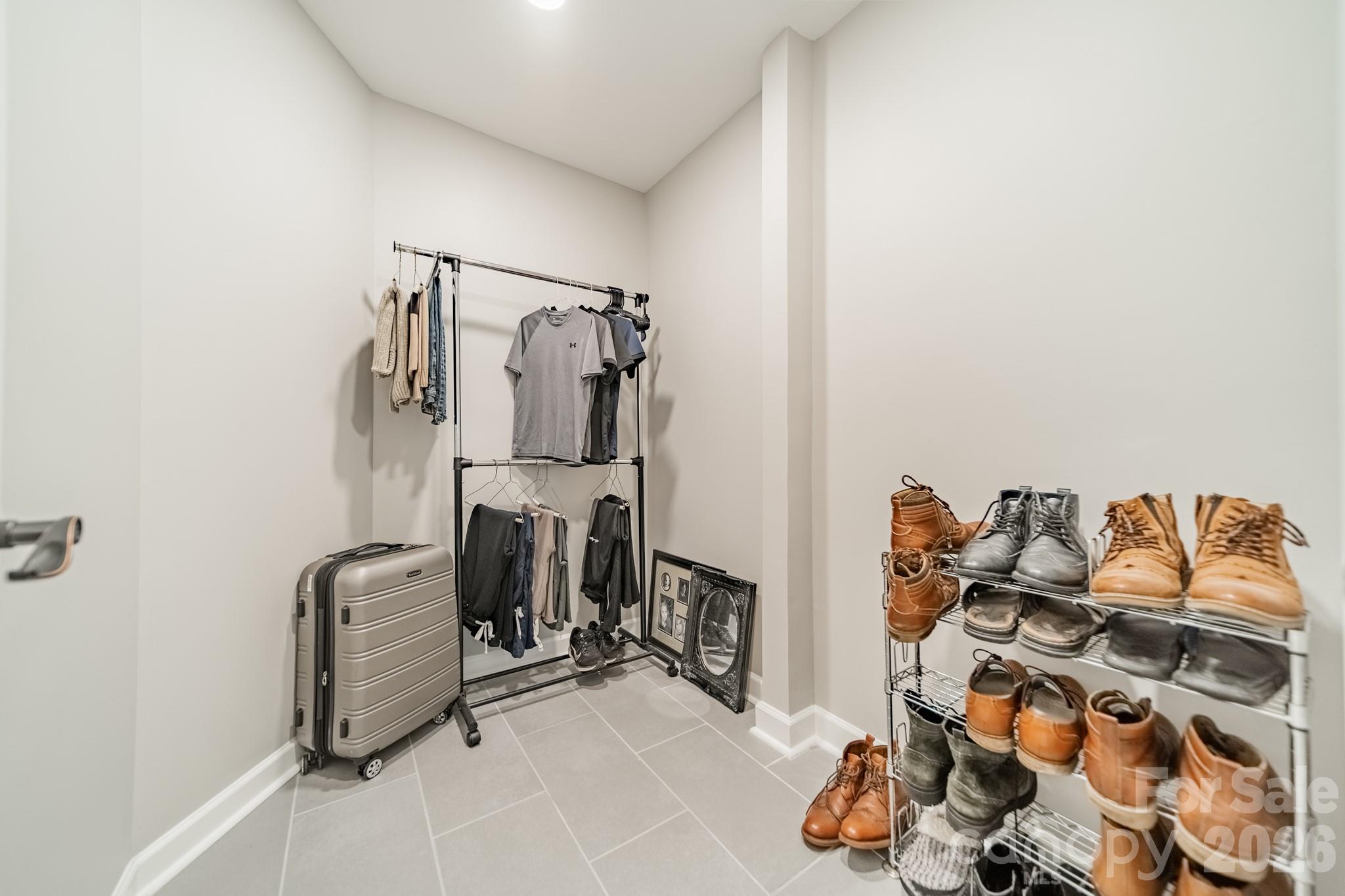 11043 Seven Coves Drive Tega Cay, SC 29708 - Photo 34 of 45 a view of walk in closet with clothes and shoes
