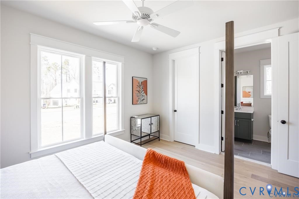 17601 Blue Is Place Moseley, VA 23120 - Photo 20 of 46 a bedroom with a bed and a table with chair
