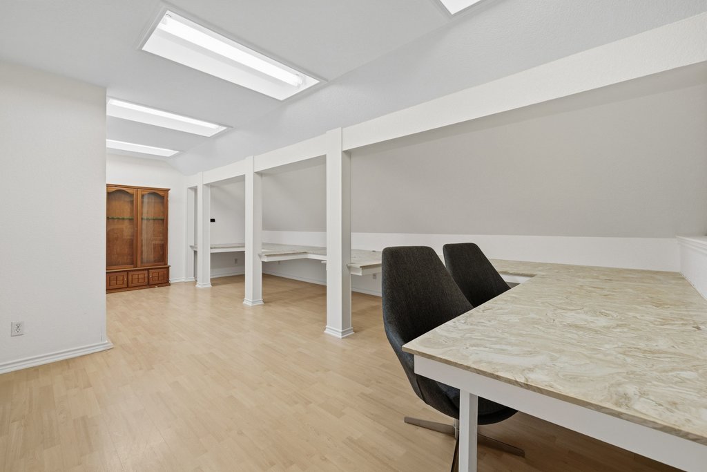 126 Pine View Loop Bastrop, TX 78602 - Photo 22 of 29 Versatile half-story loft currently used as an office with custom built-ins, offering flexibility for a studio, retreat, or additional living space.