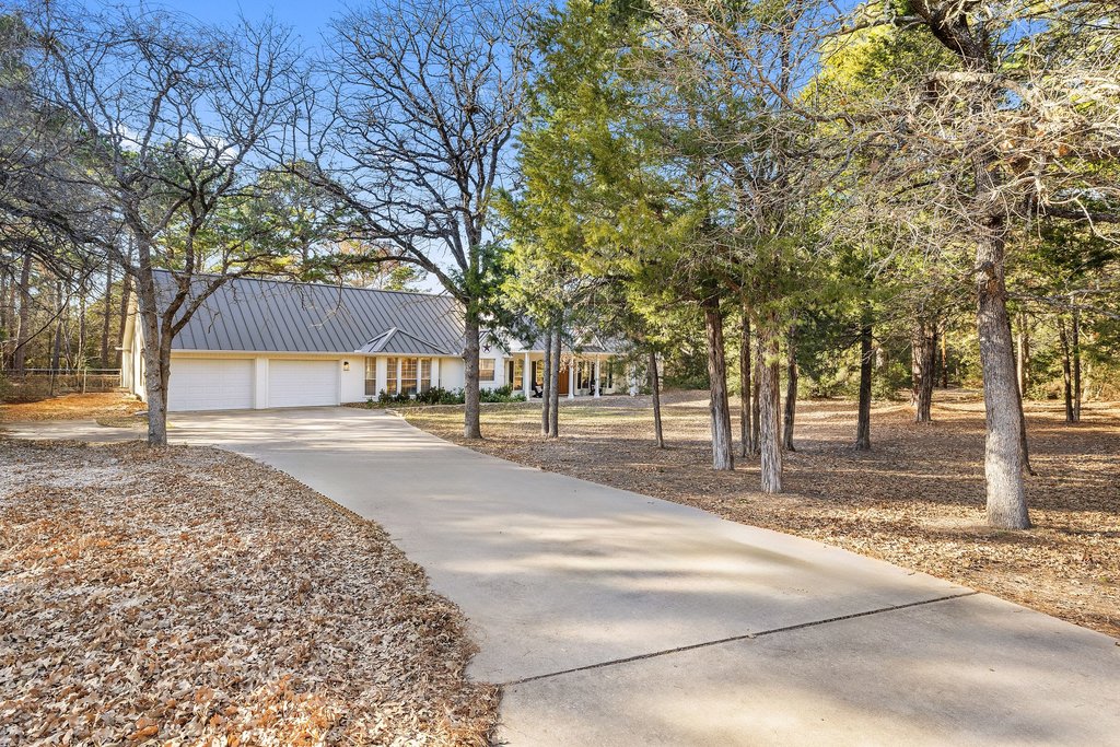 126 Pine View Loop Bastrop, TX 78602 - Photo 4 of 29 Private, picturesque driveway leading to a beautifully set-back home