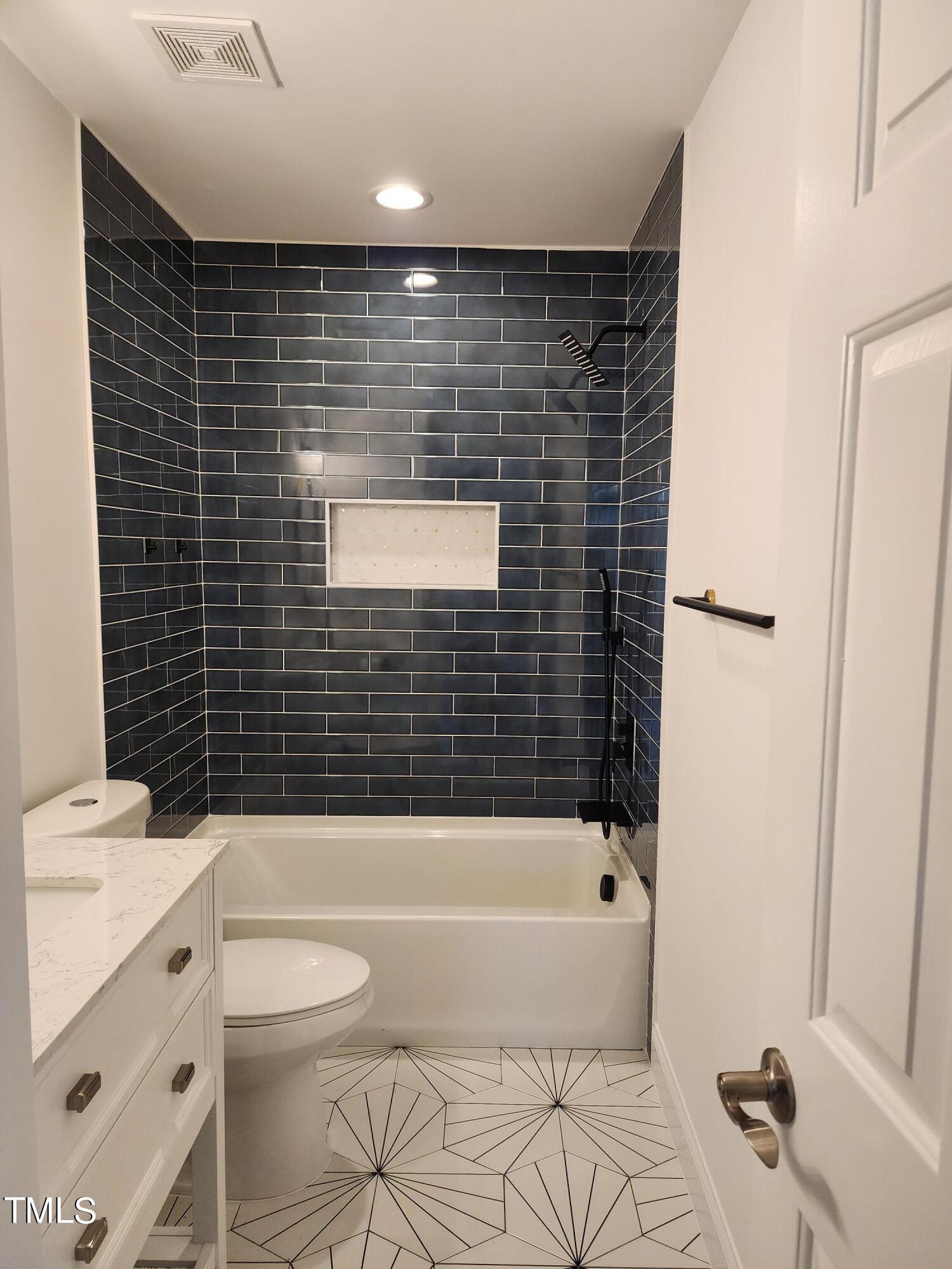 2425 Jimmy Carter Way Raleigh, NC 27610 - Photo 23 of 34 a bathroom with a bathtub and a toilet