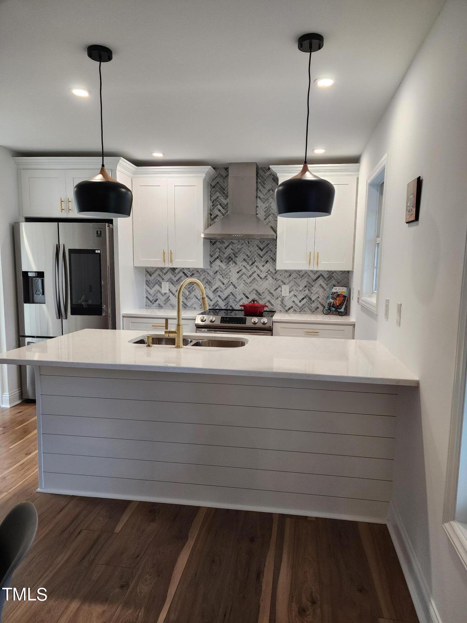2425 Jimmy Carter Way Raleigh, NC 27610 - Photo 3 of 34 a kitchen with kitchen island stainless steel appliances a sink and a counter top space