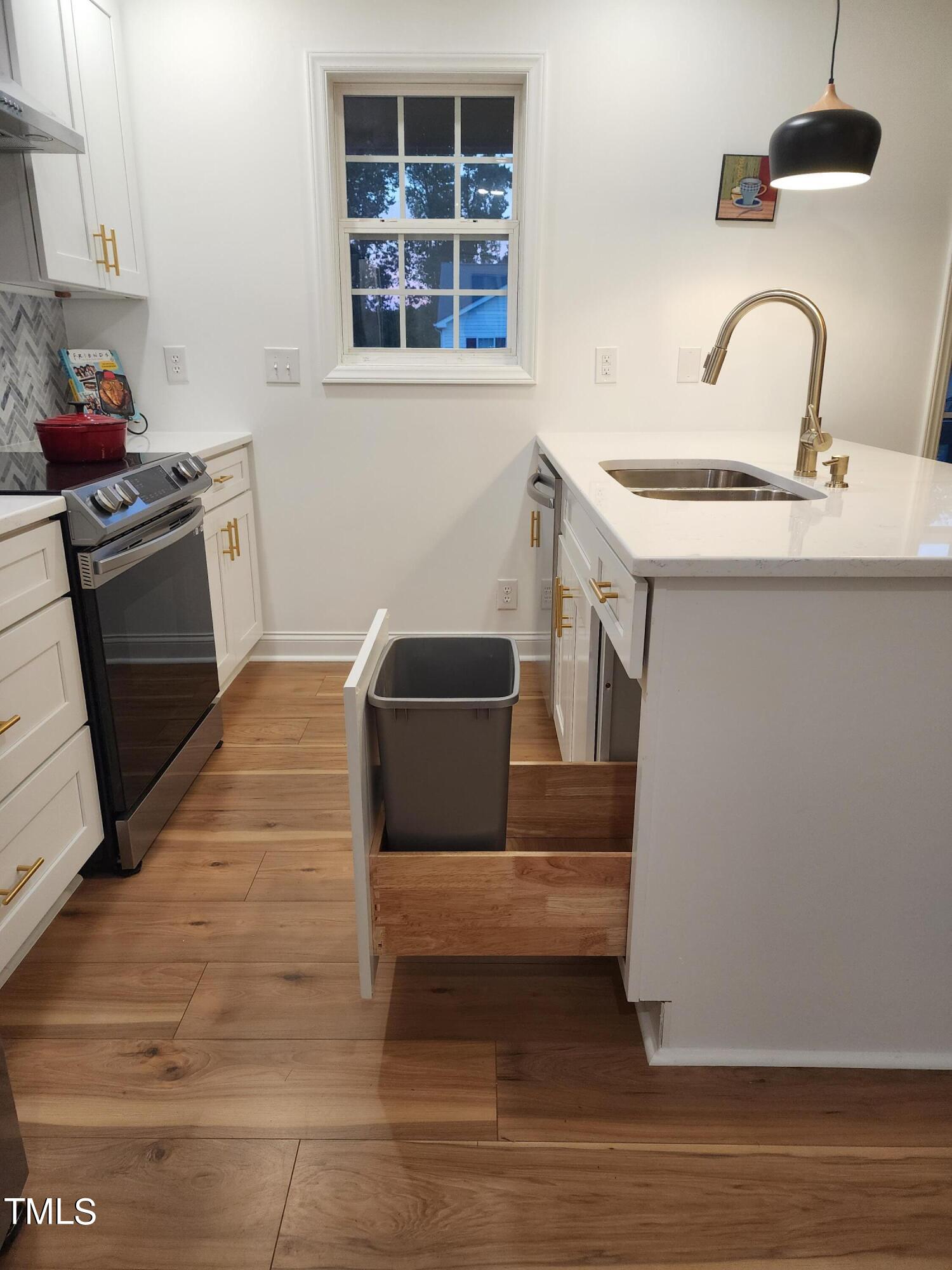 2425 Jimmy Carter Way Raleigh, NC 27610 - Photo 5 of 34 a kitchen with stainless steel appliances kitchen island a stove a sink and a refrigerator