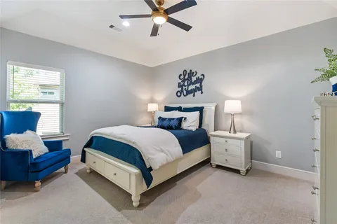 a spacious bedroom with a bed and a couch