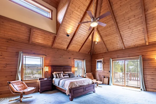 a view of a dry yard with wooden fence
