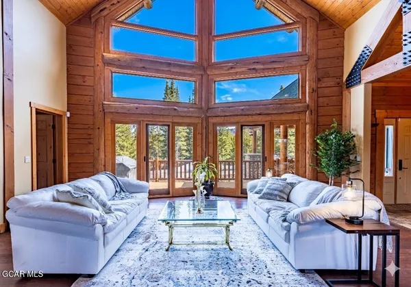 a kitchen with stainless steel appliances granite countertop a table chairs and wooden floors