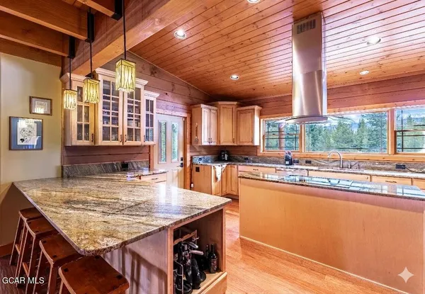 a kitchen with kitchen island granite countertop counter space and windows