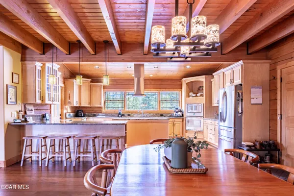 a bedroom with a bed and a large mirror on the dresser