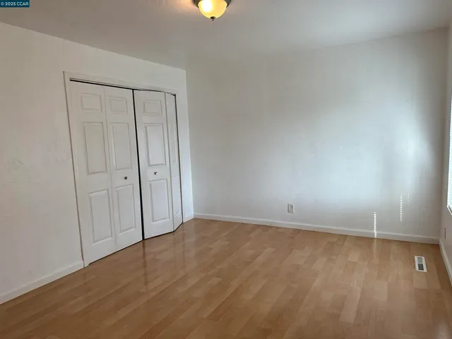 a view of an empty room and wooden floor