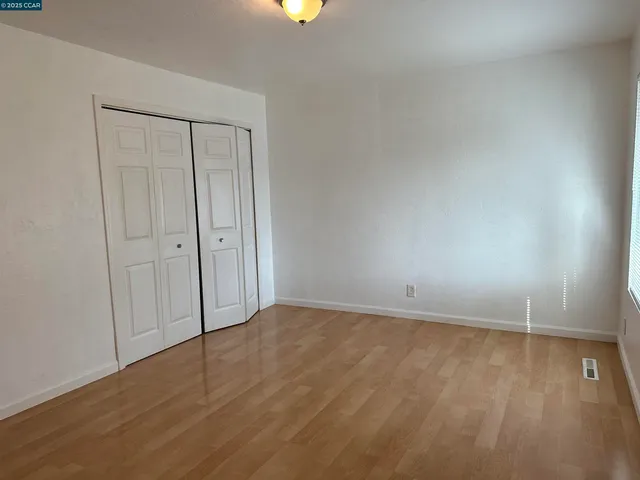 a view of an empty room and wooden floor